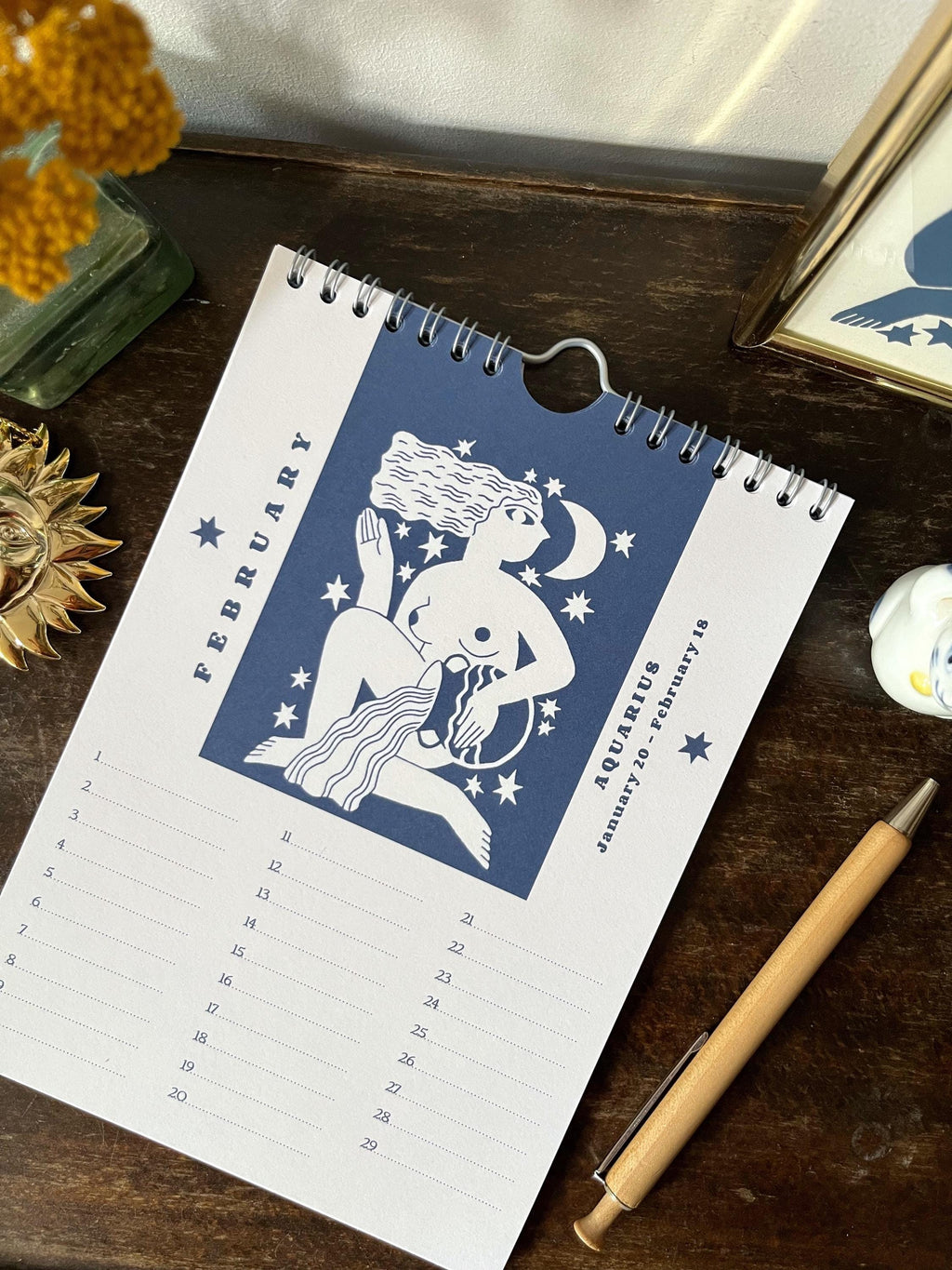 Zodiac sign perpetual calendar illustrated with linocuts