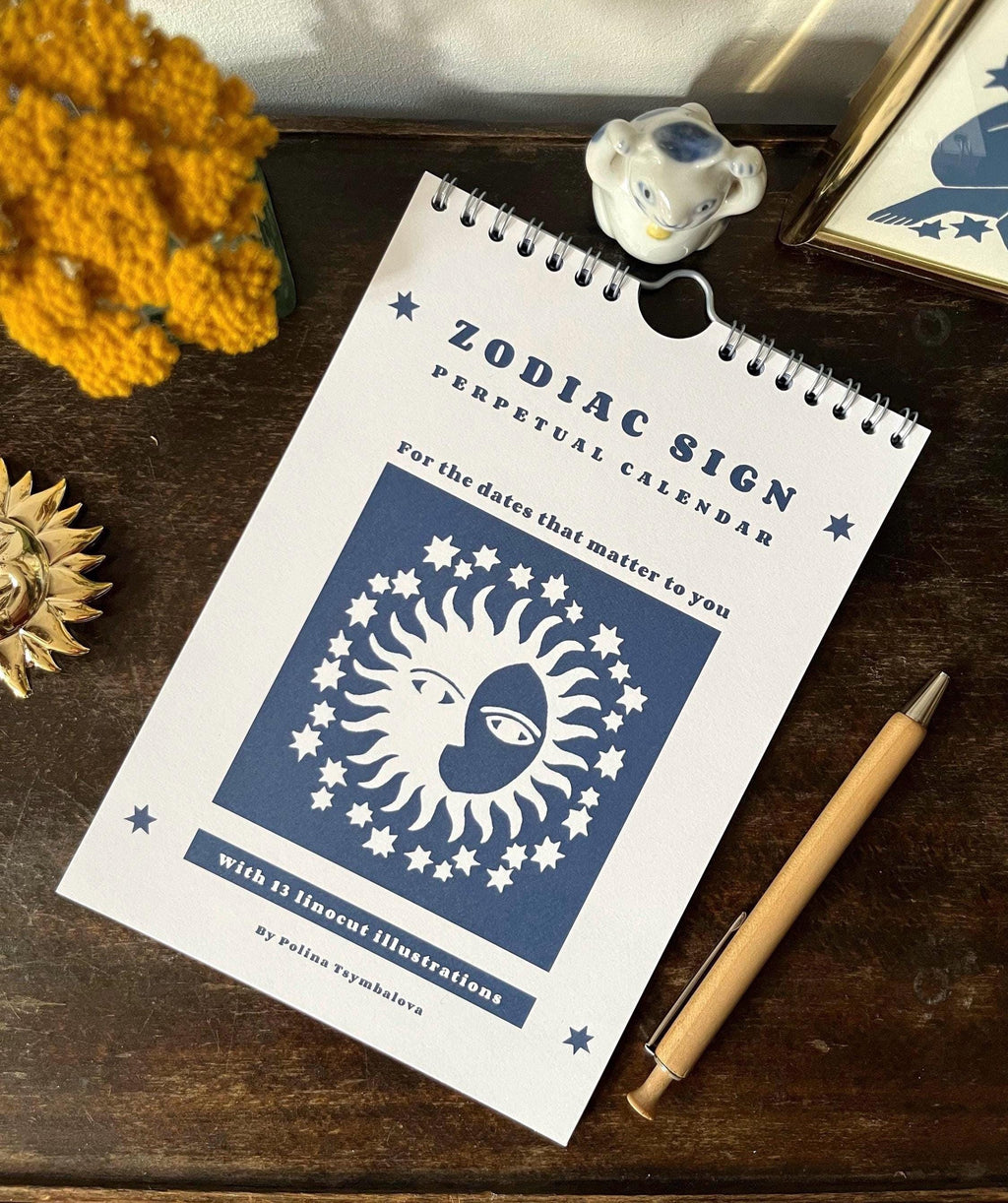 Zodiac sign perpetual calendar illustrated with linocuts