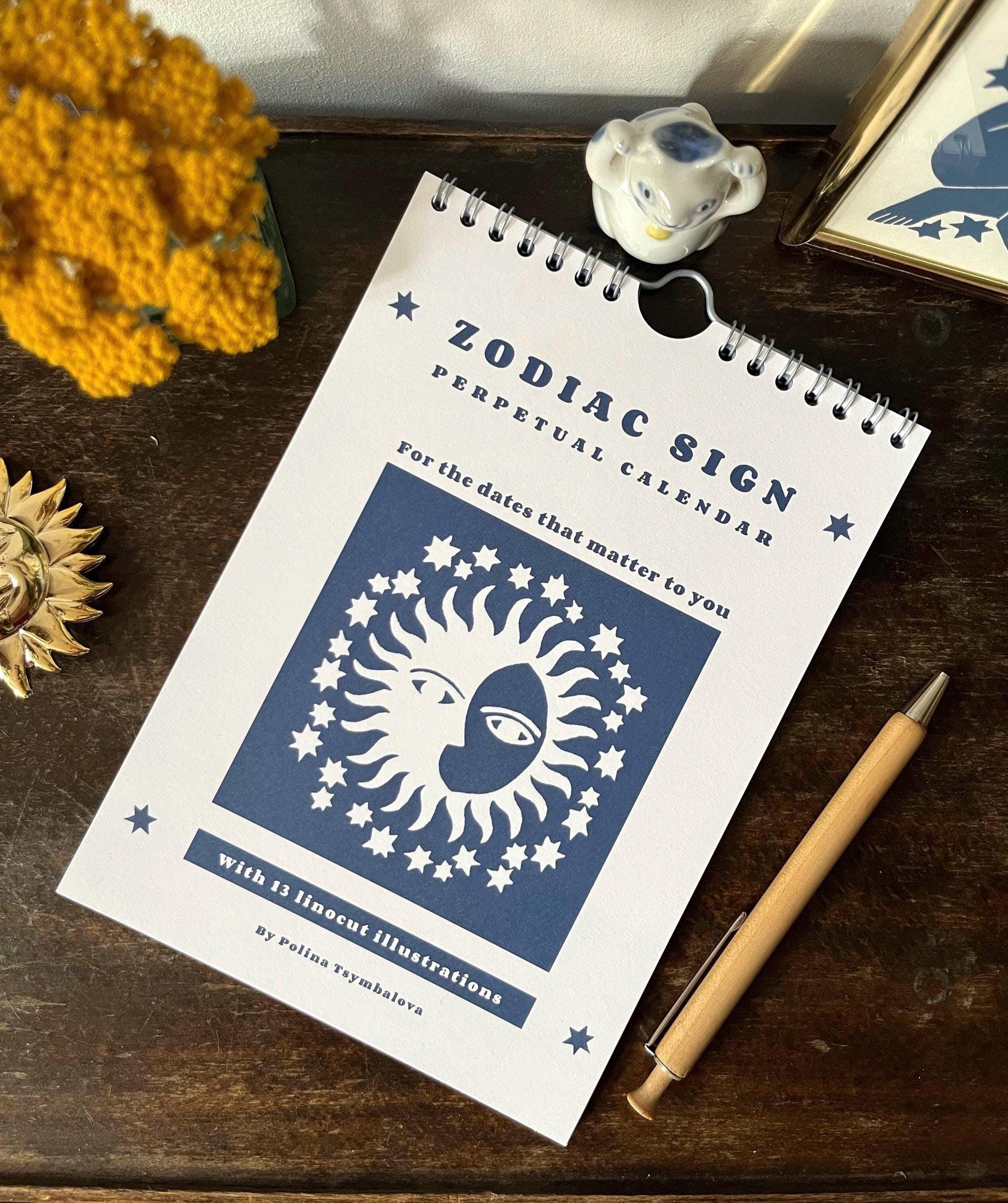 Zodiac sign perpetual calendar illustrated with linocuts